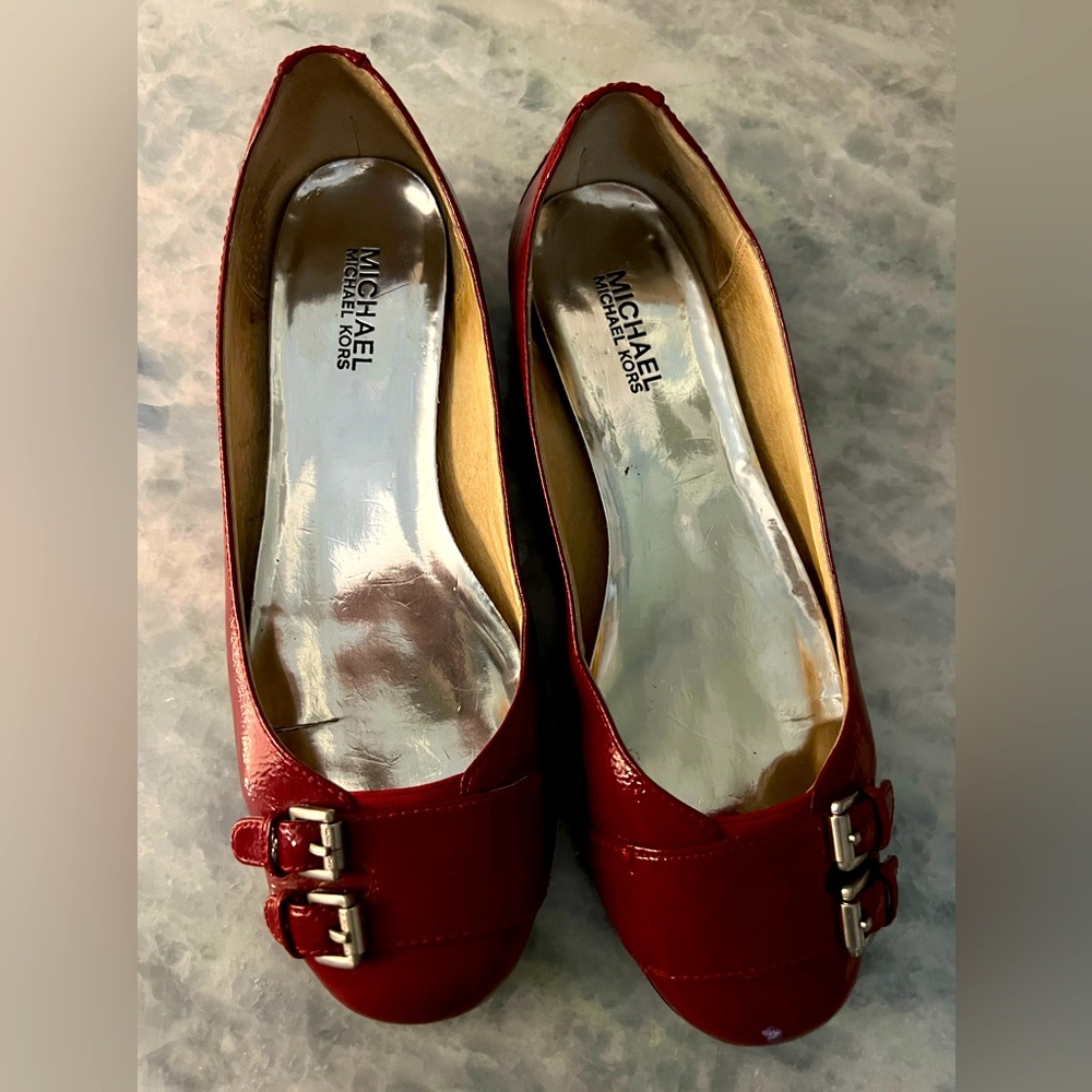 Authentic Michael Kors flats red with silver buckles size 8.5 great condition..